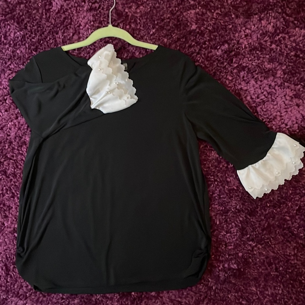 Black, three-quarter length sleeve, white lace ruffles with pearl accents.